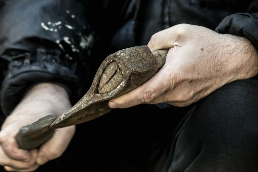 Sharpening a hatchet with a whetstone